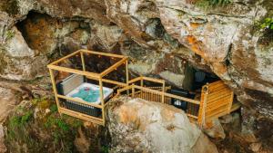 an overhead view of a pool in a cave at Cliff Hot Tub with Deck Fire Pit Mural and Pet Friendly in Rogers +34 photos