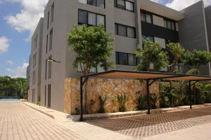 a building with a pavilion in front of it at Exclusive Boutique Apartment in Mérida Norte in Mérida