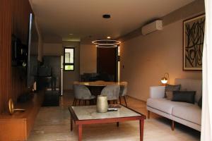 a living room with a couch and a table at Exclusive Boutique Apartment in Mérida Norte in Mérida