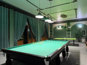 a pool table with balls on it in a room at Dacha by Bex Sueno in Samarkand +17 photos