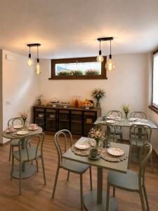 a dining room with four tables and chairs at B&B Casa Olivia in Gardone Riviera