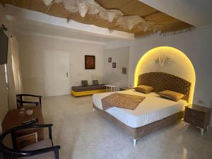 a bedroom with a large bed with an arch overhead at CoZi at Dar Faiza in Houmt Souk +22 photos