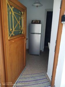 a kitchen with a refrigerator next to a door at ''RENATA'' Studio in Kithnos