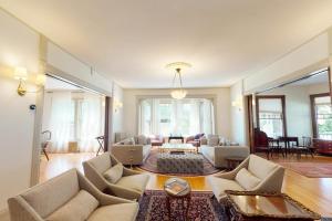 a living room with couches and a table at Beautiful home with Ping-Pong, fast WiFi & W/D - walk to dining in Wiscasset