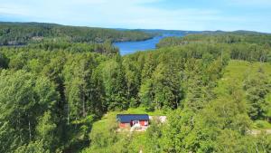 an aerial view of a house in the middle of a forest at Stuga Haget in Bengtsfors