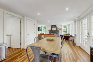 a dining room with a table and chairs at Coastal charmer with screened-in porch, grill, & AC in Boothbay Harbor