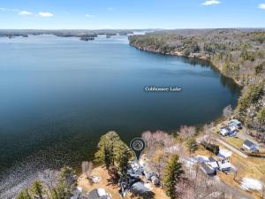 an aerial view of a lake with a house at Cobbossee Hideaway, lakefront property with dock for swimming, fishing, and sunrises in Winthrop