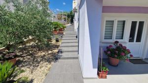 a stairway leading up to a house with potted plants at Apartman Jurjević in Krk
