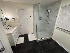 a bathroom with a shower and a sink at Elegant luxurious paradise in Decatur +11 photos