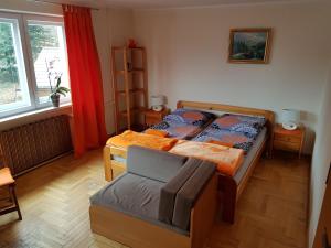 a bedroom with two beds and a chair in it at Pokoje Na Skalicy in Ustroń