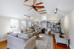 a living room with white furniture and a ceiling fan at Historical New England home, outdoor shower , Dog-friendly in Boothbay Harbor