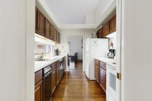 a kitchen with wooden floors and a white refrigerator at Dog-Friendly Townhouse w/Bay Views, Fast WiFi, and Partial A/C in Bar Harbor