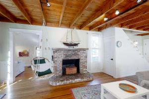 a living room with a brick fireplace and a couch at Historical New England home, outdoor shower , Dog-friendly in Boothbay Harbor +23 photos