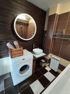 a bathroom with a washing machine and a sink at Turu 6, Quiet Central Apartment in Haapsalu +15 photos