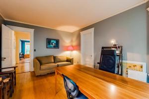 a living room with a couch and a table at Dog-friendly historical home with recent updates, porch & prime in-town location in Rockland