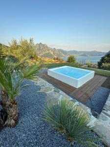a swimming pool in the middle of a yard with plants at Corte Furmignano in Solto Collina