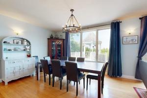 a dining room with a table and chairs at Expansive Modern Home w/ Ocean View, Gorgeous Garden & Dog-friendly in East Boothbay