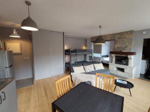 a living room with a bed and a dining room table at Turu 6, Quiet Central Apartment in Haapsalu