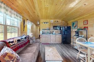 a living room with a couch and a kitchen at Cozy Cabin with Ocean and Mountain Views, Free Internet in Sullivan
