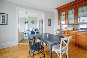 a kitchen and dining room with a table and chairs at Waterfront, walkable, updated home with harbor views & partial AC in Camden +10 photos