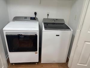 a stove and a microwave next to a refrigerator at Elegant luxurious paradise in Decatur