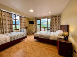 a hotel room with two beds and a balcony at MONTEVERDIA - Hotel & Resort in Pozuzo
