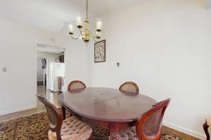 a dining room with a wooden table and chairs at Dog-Friendly Townhouse w/Bay Views, Fast WiFi, and Partial A/C in Bar Harbor