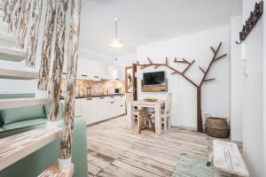 a kitchen with a table and a dining room at Habitat Apartments in Krakow