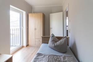 a bedroom with a bed with a pillow on it at Melanie in Lenz +6 photos