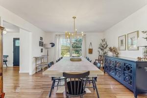 a dining room with a large table and chairs at Newly Renovated Charming House with Cozy Fireplace & Outdoor Entertainment Areas in Rockport +15 photos