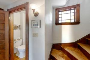 a bathroom with a toilet and a window at Oceanfront house with dock, kayaks, deck, and gas grill in Boothbay Harbor +36 photos