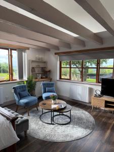 a living room with two chairs and a coffee table at Ben Wyvis View Annexe in Inverness