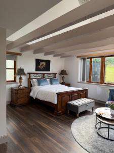 a bedroom with a large bed with blue pillows at Ben Wyvis View Annexe in Inverness
