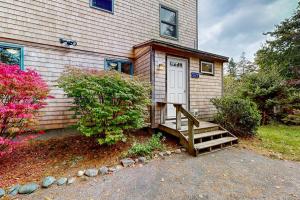 a house with a staircase leading to a door at Dog-friendly ocean-view duplex with wood stoves, decks, grills, kitchens, ACs in Southwest Harbor