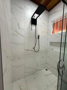 a bathroom with a shower with white marble walls at Casa Pé da Serra in Estivado +23 photos
