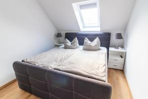 a bedroom with a large bed with two pillows on it at Monique in Lenz +7 photos
