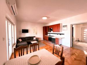 a living room and kitchen with a couch and a table at Apartment Sofia in Kožino