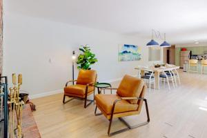 a living room with two chairs and a table at Water-view retreat with beach access, deck, grill, EV charger & lawn games in North Harpswell