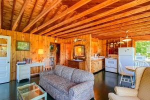 a living room with a couch and a kitchen at Classic home overlooking the St George River with deck & great views in Saint George