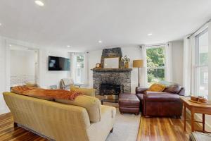 a living room with two couches and a fireplace at Coastal charmer with screened-in porch, grill, & AC in Boothbay Harbor