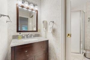 a bathroom with a sink and a mirror at Newly-furnished condo with loft, fast WiFi, partial AC, grills & yard access in Bar Harbor +13 photos