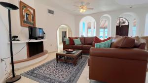 a living room with a couch and a tv at Recently Renovated Oceanview Home Casa Hebe in Puerto Peñasco