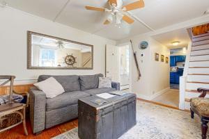 a living room with a couch and a ceiling fan at Nautical vacation rental in in walkable downtown with harbor view, grill & deck in Boothbay Harbor