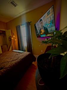 a bedroom with a bed and a flat screen tv at La Suite de Antonio Shared Property PRIVATE stay NYC 18mins in North Bergen +12 photos