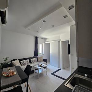 a living room with a couch and a table at Apartma Sparkle in Koper