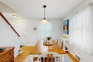 a dining room with a table and chairs at Charming Coastal House with Cozy Living Spaces and Outdoor Firepit in Winter Harbor