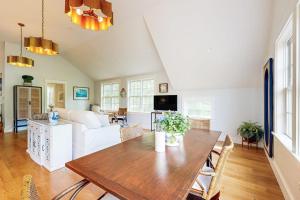 a living room with a table and a couch at Brand new guest apartment with furnished deck, fast WIFI, dock, & water views in Boothbay Harbor +13 photos