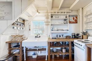 a kitchen with a sink and a stove at Iconic downtown retreat with firepit & fireplace- walk to Harbor Footbridge in Boothbay Harbor +11 photos