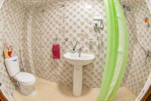 a bathroom with a toilet and a sink at Dar Mayssa Fez in Fez
