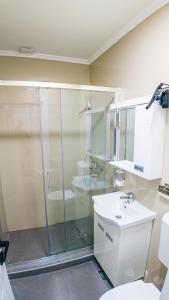 a bathroom with a shower and a toilet and a sink at Family Inn in Subotica +38 photos